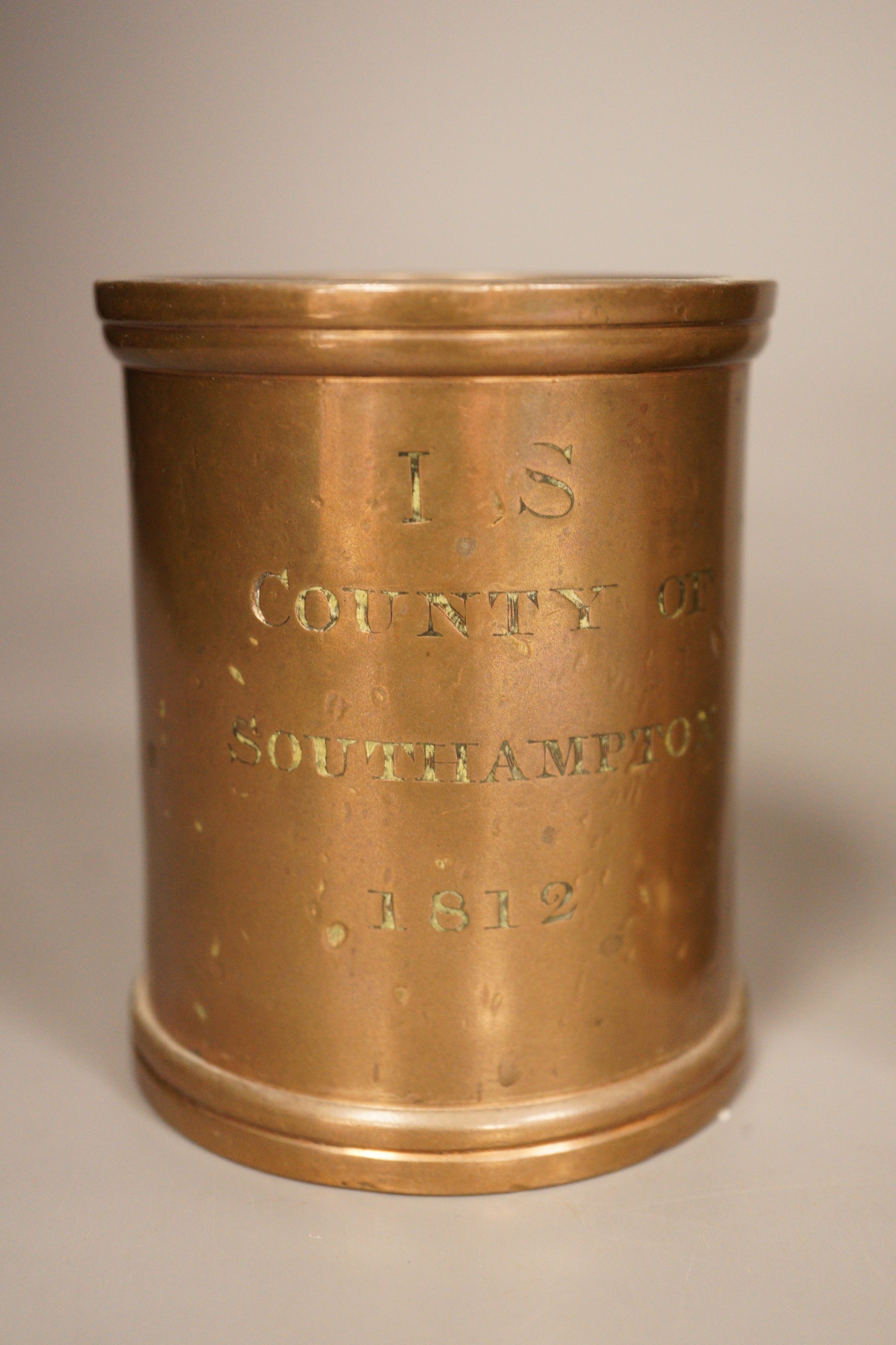 Three early 19th century graduated bronze measures, the larger marked ‘quart Winchester’, the others marked ‘County of Southampton, 1812 (3). 17cm